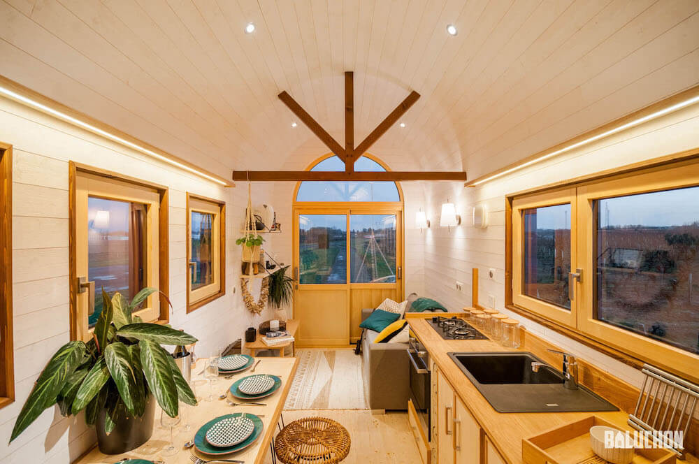 A stunning tiny home with dining table and living room