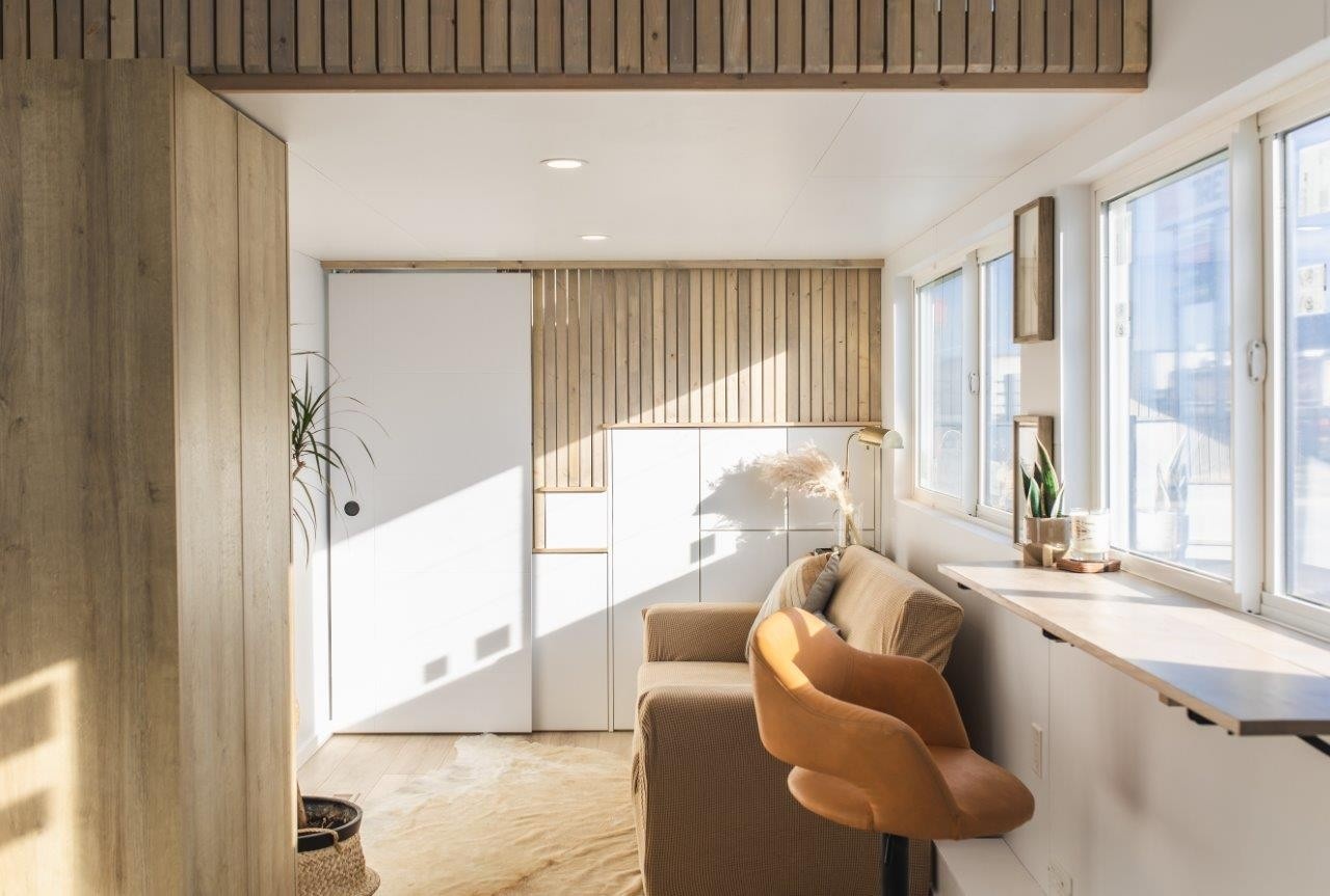 Tiny Home on Wheels living room with soft natural wood and flat wood panel walls